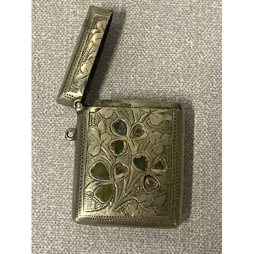 386 - White metal cigarette case along with white metal Vesta case decorated with shamrocks.