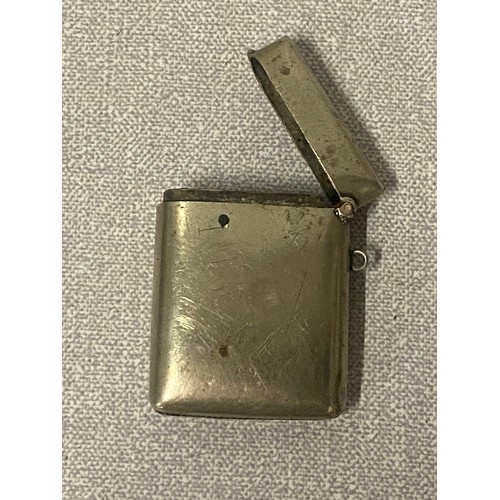 386 - White metal cigarette case along with white metal Vesta case decorated with shamrocks.