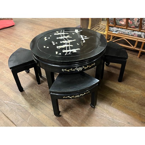 66 - a Chinese lacquered & mother of pearl tea table with 4 stools and glass top.