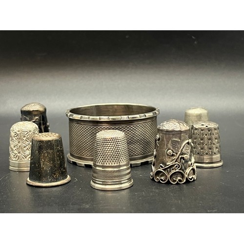 44 - 7 Silver hallmarked thimbles along with silver hallmarked napkin ring. 
45.85g