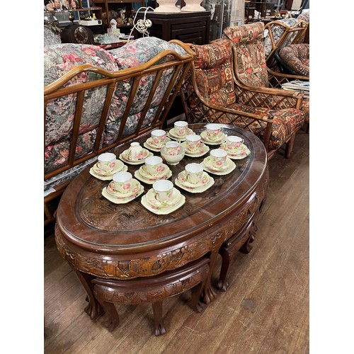 43 - Oriental highly carved oval coffee table with glass top protector & 6 stools.
table 120cm x 53cm