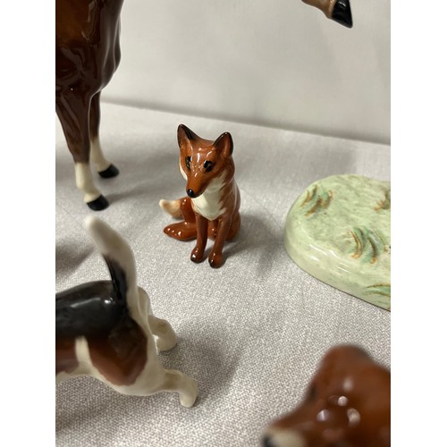 276 - 2 vintage beswick huntsmen on horseback along with hounds & fox.