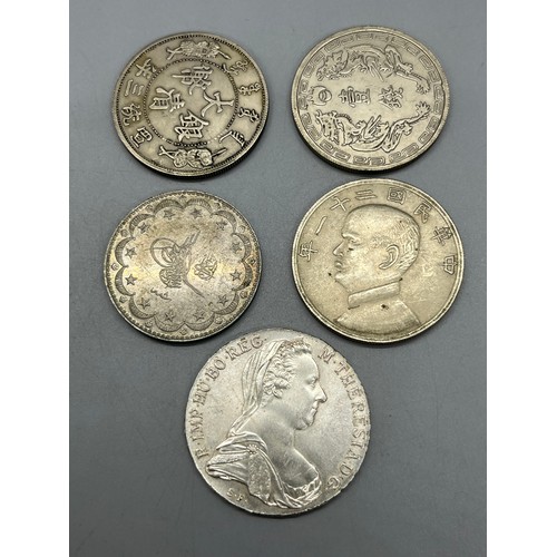 425 - 5 various foreign coins to include Chinese 1 dollar possibly silver.