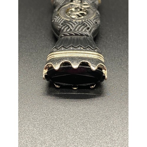 58 - Sgian Dubh with thistle and stone top and lion rampant crest.