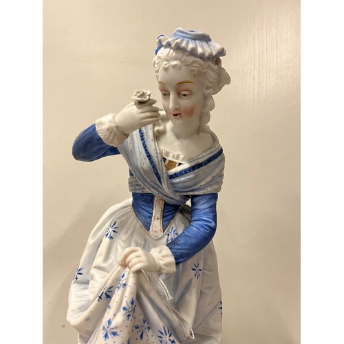 63 - Large Victorian bisque figurine of lady lifting skirt looking at flower, possibly Dresden?
15