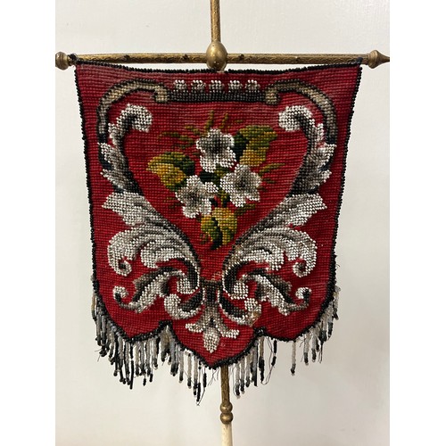 23 - Victorian aesthetic movement pole screen with beadwork shield shaped banner upon brass pole supporte... 