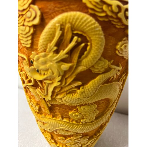 100B - Chinese tangerine cinnabar vase depicting dragon scene. 9.5 inches tall