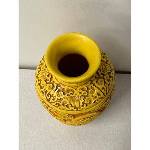 100B - Chinese tangerine cinnabar vase depicting dragon scene. 9.5 inches tall