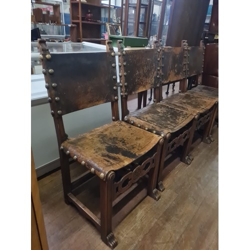 99 - Seven 19th century Jacobean style Walnut and leather chairs; Leather and stud trim finish. Carved cr... 