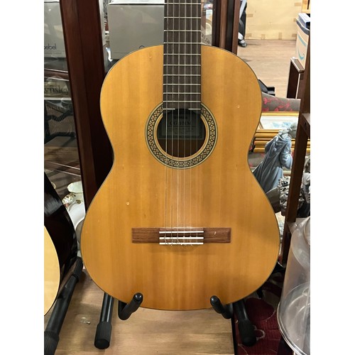 200 - Yamaha CG-101M acoustic guitar along with 1 other.