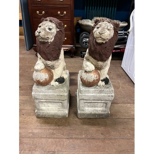 111 - Pair of vintage stone lions standing on square plinths. 24 inches tall