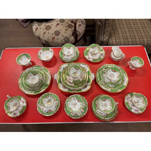 110A - Antique 36 Piece Coalport green 'Batwing pattern' with finely enamelled floral sprays within gilt re... 