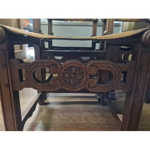 99 - Seven 19th century Jacobean style Walnut and leather chairs; Leather and stud trim finish. Carved cr... 