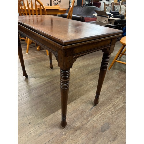 147 - Antique card table on porcelain castor feet.