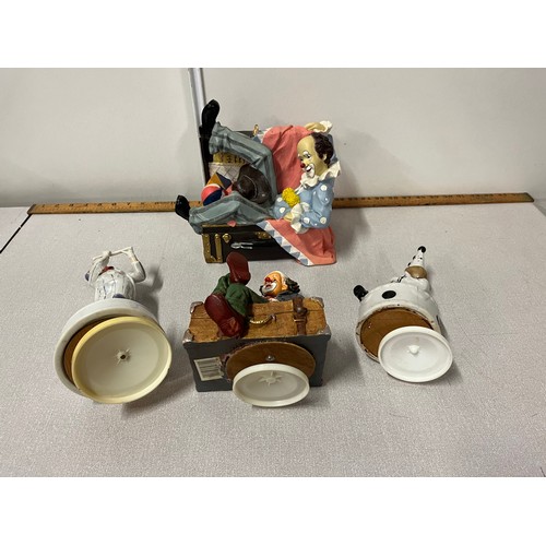 317 - 3 musical clown figures & one in suitcase