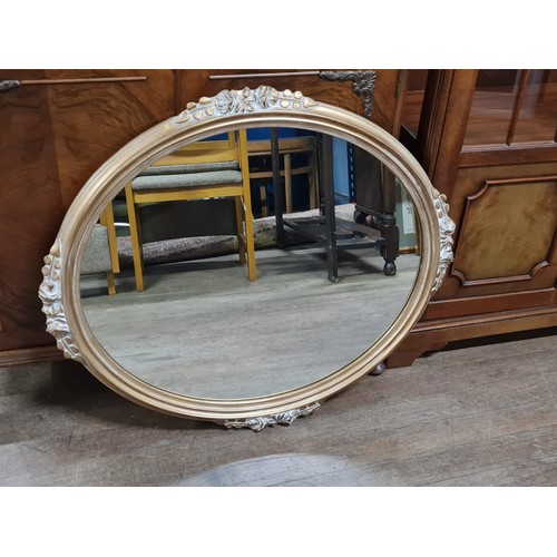 53 - Oval mirror with carved  flower detail made in Belgium.
32