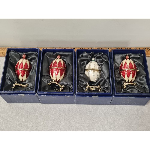 213 - 4 Atlas editions Faberge style decorative eggs with stands.