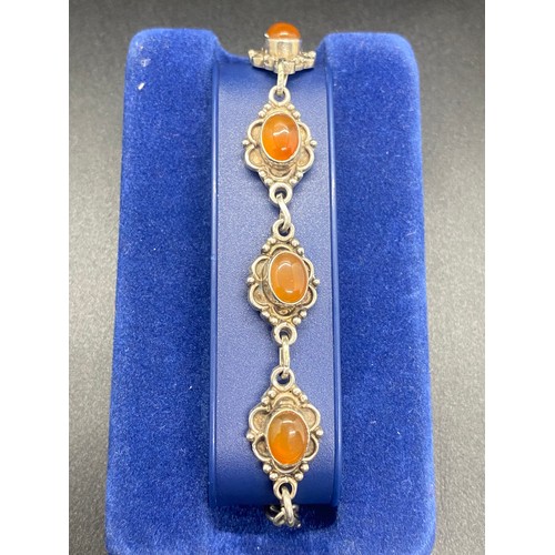 17 - Silver and amber decorative bracelet.