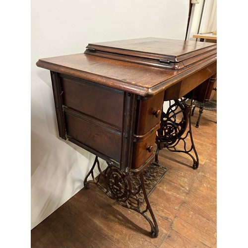 8 - Antique Singer sewing machine & table with 4 drawers, fully integrated with cast iron foot mechanism... 