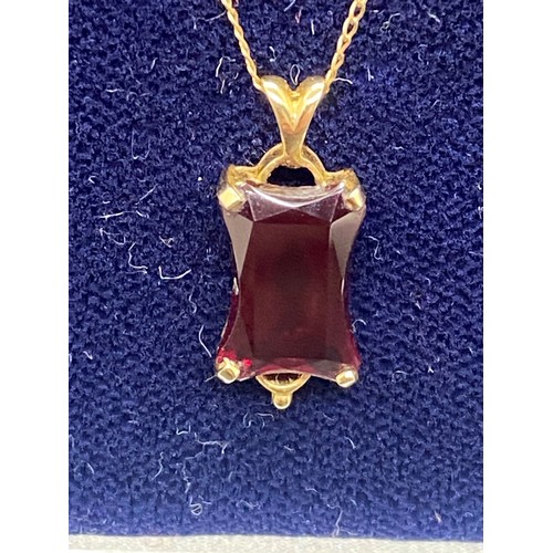 172 - 14k gold and ruby pendant and chain.