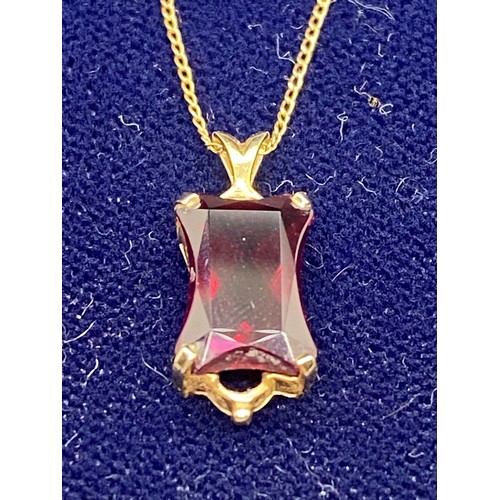 172 - 14k gold and ruby pendant and chain.