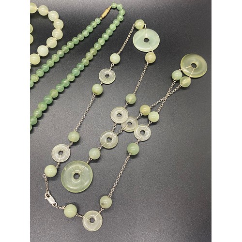 174 - Two Chinese jade necklaces and green glass necklace.