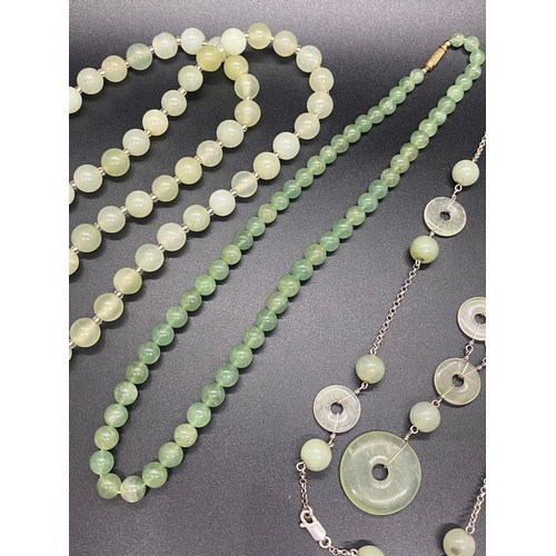 174 - Two Chinese jade necklaces and green glass necklace.