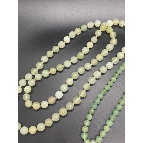 174 - Two Chinese jade necklaces and green glass necklace.