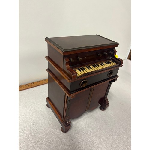 3 - A late 19th century novelty musical smokers cabinet in the form of a harmonium