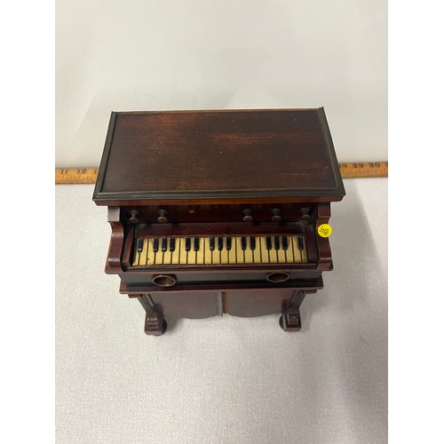 3 - A late 19th century novelty musical smokers cabinet in the form of a harmonium