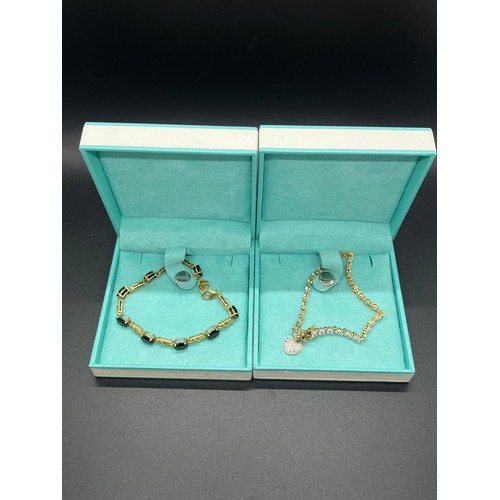 22 - 2 gem set silver bracelets.