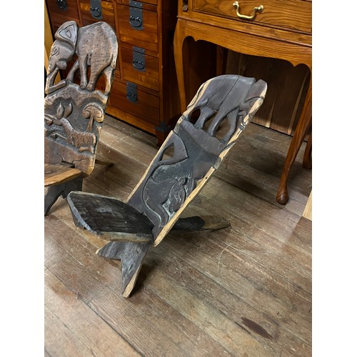 64 - Pair of wooden African hand carved birthing chairs.