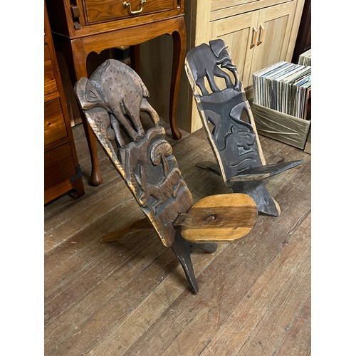 64 - Pair of wooden African hand carved birthing chairs.