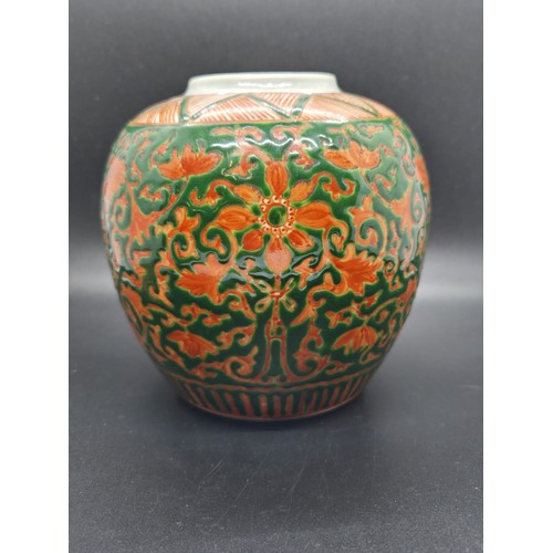 286 - Chinese green-ground enamelled lidded ginger jar upon a craved hardwood base.  Jar marked to base. 7... 