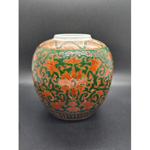 286 - Chinese green-ground enamelled lidded ginger jar upon a craved hardwood base.  Jar marked to base. 7... 