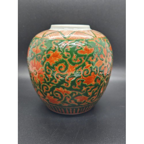 286 - Chinese green-ground enamelled lidded ginger jar upon a craved hardwood base.  Jar marked to base. 7... 