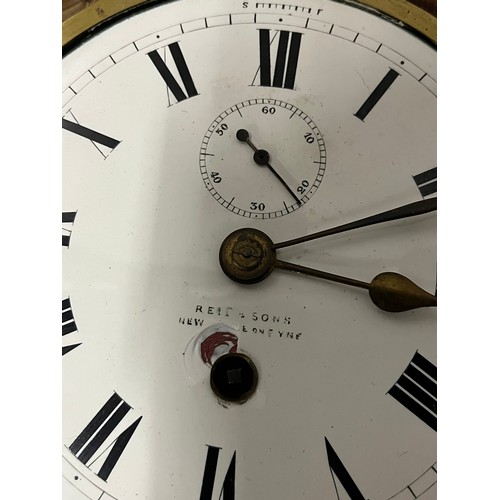 82 - Antique bulk head clock; Reid and Sons of New York. Fitted within an oak rope carved wooden body. In... 