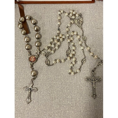 425 - 3 Holy Bibles along with 4 sets of Rosary beads.