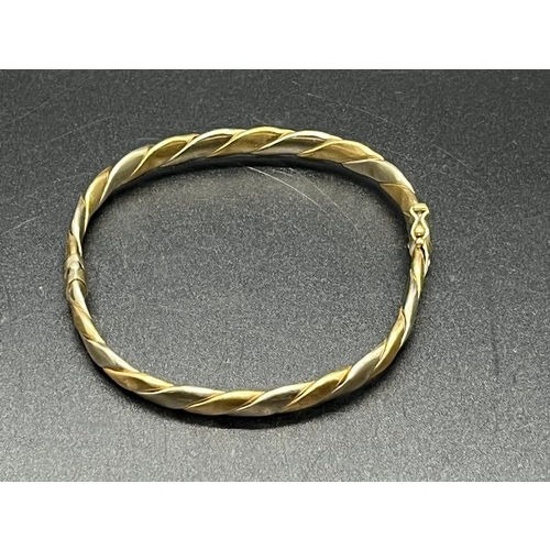 86 - 9ct 2 tone gold bangle 10.7 grams