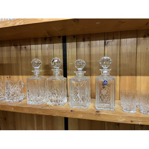 300 - 3 Shelves full of crystal to include 4 decanters, glasses & vases etc.