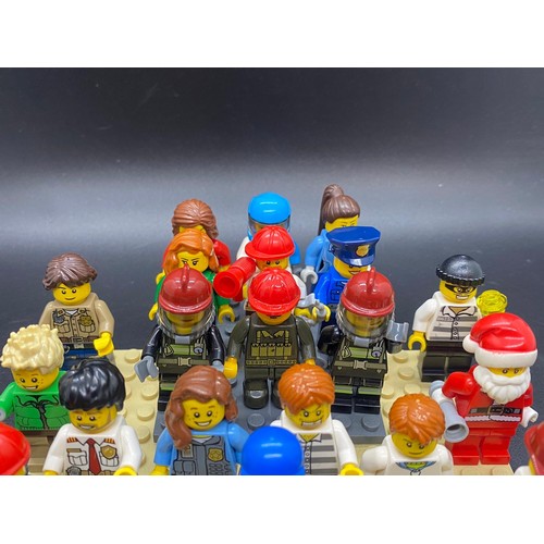 23 - 25 Lego figures to include Santa, fireman, police, miner etc.