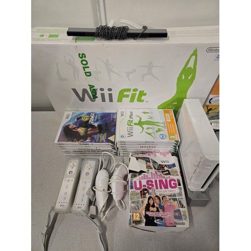 390 - Wii bundle to include Console, Wii fit, Metallica guitar hero, controllers & games etc.