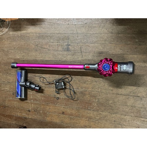 597 - Hand held dyson with charger (working)