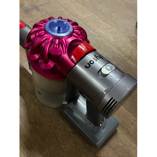 597 - Hand held dyson with charger (working)