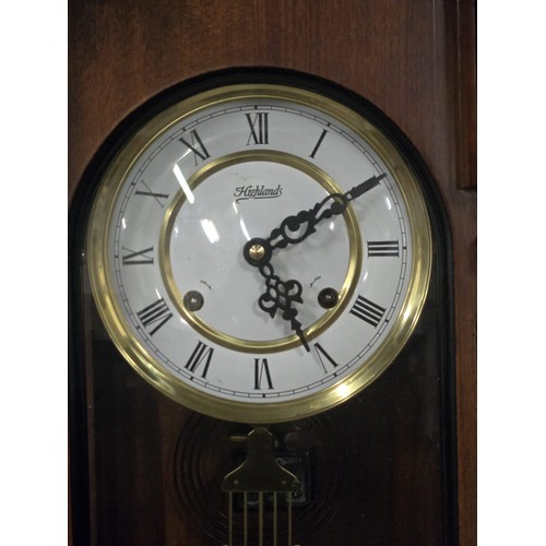 616 - Highlands wooden cased wall clock with key. working.