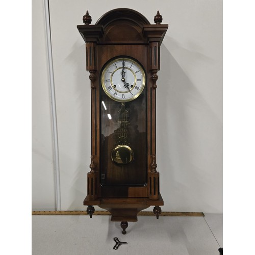 616 - Highlands wooden cased wall clock with key. working.