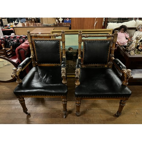 130 - A pair of Victorian oak library chairs