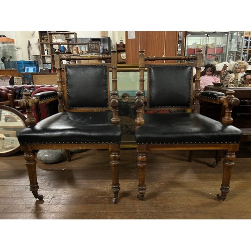 130 - A pair of Victorian oak library chairs