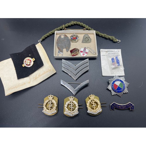 12 - Selection of pin badges etc to include Royal Army Medical Corps cap badges etc.