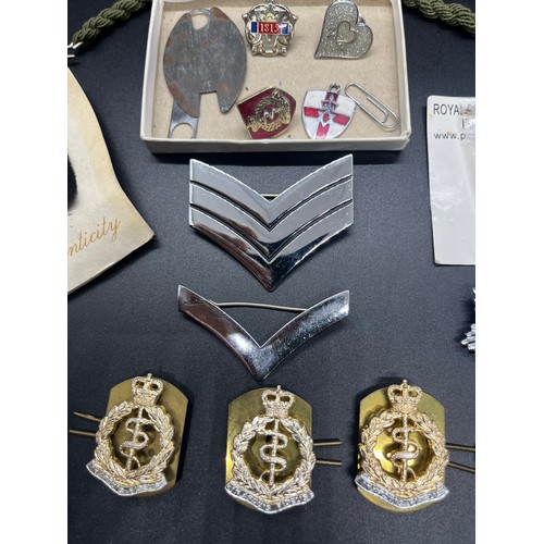 12 - Selection of pin badges etc to include Royal Army Medical Corps cap badges etc.